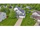 Charming two-story home with a lush green lawn, a long driveway, and curb appeal at 6822 Woodford Ln, Indianapolis, IN 46237
