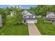 Charming two-story home with a lush green lawn, a long driveway, and curb appeal at 6822 Woodford Ln, Indianapolis, IN 46237