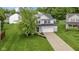 Charming two-story home with a lush green lawn, a long driveway, and curb appeal at 6822 Woodford Ln, Indianapolis, IN 46237