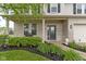 Inviting front porch with brickwork, decorative shrubbery, and a charming entrance at 6822 Woodford Ln, Indianapolis, IN 46237
