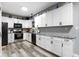 Modern kitchen with white cabinets, gray countertops, and stainless steel appliances at 6822 Woodford Ln, Indianapolis, IN 46237