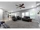 Spacious living room with open kitchen view, fireplace, and comfortable seating at 6822 Woodford Ln, Indianapolis, IN 46237