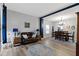 Open-concept living and dining area with hardwood floors and modern decor at 6822 Woodford Ln, Indianapolis, IN 46237