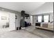 Large main bedroom featuring two windows, neutral walls and carpet and a decorative pillar at 6822 Woodford Ln, Indianapolis, IN 46237