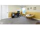 This office includes a desk and chair, wicker chair, and ample space for productivity at 6822 Woodford Ln, Indianapolis, IN 46237