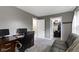 A home office features a black desk chair, computer, and a view into the closet at 6822 Woodford Ln, Indianapolis, IN 46237