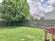 Fenced backyard featuring a lush lawn and mature tree providing shade at 6824 W Philadelphia Dr, McCordsville, IN 46055