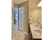 Bathroom view showing a double sink vanity and doorway leading to an adjacent room with blinds at 6824 W Philadelphia Dr, McCordsville, IN 46055