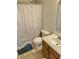 Bathroom view highlighting a tiled shower, a single sink vanity, and a toilet with a colorful shower curtain at 6824 W Philadelphia Dr, McCordsville, IN 46055