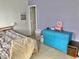 Bedroom featuring a blue dresser, light purple walls, and a bed with striped bedding at 6824 W Philadelphia Dr, McCordsville, IN 46055