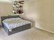 Spacious bedroom featuring a gray bed frame and hanging guitars on the wall at 6824 W Philadelphia Dr, McCordsville, IN 46055
