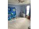 Bedroom featuring a blue accent wall and a play tent and toy organizer and neutral carpet flooring at 6824 W Philadelphia Dr, McCordsville, IN 46055