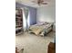 Cozy bedroom featuring a built-in bookshelf, a window with curtains, and carpeted flooring at 6824 W Philadelphia Dr, McCordsville, IN 46055