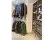 Organized closet with hanging racks and built-in shelving, providing ample storage space and functionality at 6824 W Philadelphia Dr, McCordsville, IN 46055