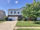 Charming two-story home featuring brick accents, a well-manicured lawn, and an attached two-car garage at 6824 W Philadelphia Dr, McCordsville, IN 46055
