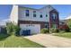 Two-story home with a brick-accented facade and an attached garage on a sunny day with nice landscaping at 6824 W Philadelphia Dr, McCordsville, IN 46055