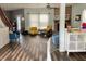 Open-concept living space with hardwood floors, a fireplace, and stylish decor, leading to other areas of the home at 6824 W Philadelphia Dr, McCordsville, IN 46055