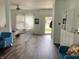Open living area with a view towards the entry, hardwood floors, white trim, and comfortable seating at 6824 W Philadelphia Dr, McCordsville, IN 46055