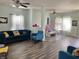 Spacious living room area with ceiling fans, hardwood floors, a baby safety gate and modern furnishings at 6824 W Philadelphia Dr, McCordsville, IN 46055