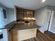 Charming home bar featuring sleek countertops, wine rack, cabinets, mini-fridge, and modern backsplash at 6924 Havenmoor Pl, Indianapolis, IN 46250