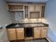 Home bar featuring granite countertops, a beverage fridge, and glass front cabinets at 6924 Havenmoor Pl, Indianapolis, IN 46250