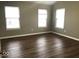 Bedroom featuring three windows, new paint, and hardwood floors at 6924 Havenmoor Pl, Indianapolis, IN 46250