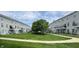 Exterior view of the Townhouse, with well-manicured lawns, landscaping, and a sidewalk at 6924 Havenmoor Pl, Indianapolis, IN 46250