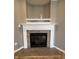 Close-up view of a classic fireplace with white mantel and decorative tile surround at 6924 Havenmoor Pl, Indianapolis, IN 46250