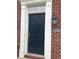 Red brick home with an elegant front door and trim at 6924 Havenmoor Pl, Indianapolis, IN 46250