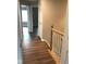 The hallway has new hardwood floors and a staircase with wood railing at 6924 Havenmoor Pl, Indianapolis, IN 46250