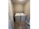 Utility room with laundry machines and overhead shelf at 6924 Havenmoor Pl, Indianapolis, IN 46250