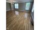 Open living room featuring hardwood floors, crown molding, and bright windows at 6924 Havenmoor Pl, Indianapolis, IN 46250