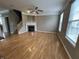 Bright living room with wood floors, fireplace, and large windows provides a cozy atmosphere at 6924 Havenmoor Pl, Indianapolis, IN 46250