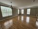 Bright living room with beautiful hardwood floors and an abundance of natural light from large windows at 6924 Havenmoor Pl, Indianapolis, IN 46250