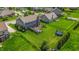 Aerial view of the backyard with a trampoline, hot tub, and green grass at 7320 Corwin Ct, Indianapolis, IN 46259