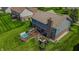 Aerial view of a home's backyard featuring a wooden deck, a hot tub, and lush green lawn at 7320 Corwin Ct, Indianapolis, IN 46259