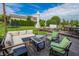 Cozy outdoor living space with sectional seating, an umbrella-shaded area, and lush greenery, perfect for relaxation at 7320 Corwin Ct, Indianapolis, IN 46259