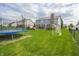 Large backyard with a trampoline, soccer goal, and well-maintained lawn at 7320 Corwin Ct, Indianapolis, IN 46259