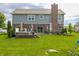 View of a backyard featuring a patio with a hot tub and mature trees at 7320 Corwin Ct, Indianapolis, IN 46259