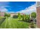 Expansive backyard with lush lawn, mature trees, and a play area, perfect for Gathering activities and relaxation at 7320 Corwin Ct, Indianapolis, IN 46259
