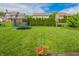 Spacious backyard with lush green grass, mature trees, and a trampoline at 7320 Corwin Ct, Indianapolis, IN 46259