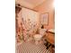 Well-lit bathroom with a floral shower curtain, wood vanity, and black and white tiled floor gives it a clean look at 7320 Corwin Ct, Indianapolis, IN 46259