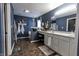 Stylish bathroom with double sink vanity, decorative mirror, and hanging planters, offering a serene, modern feel at 7320 Corwin Ct, Indianapolis, IN 46259