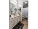 Bright bathroom with a white vanity, neutral countertop, and an open doorway to the shower/toilet area at 7320 Corwin Ct, Indianapolis, IN 46259