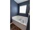 Relaxing soaking tub with tile surround and sleek faucet, designed for comfort and a spa-like experience at 7320 Corwin Ct, Indianapolis, IN 46259
