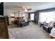 Spacious bedroom with neutral carpet, a four-poster bed, and ample seating arrangements at 7320 Corwin Ct, Indianapolis, IN 46259