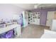 Spacious bedroom with carpet, purple walls, ceiling fan, and white shelving at 7320 Corwin Ct, Indianapolis, IN 46259