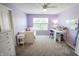 Bright bedroom with a bed, desk, and ample natural light from the window at 7320 Corwin Ct, Indianapolis, IN 46259
