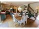 Bright dining area with stylish chandelier, wooden table, and view into the gourmet kitchen at 7320 Corwin Ct, Indianapolis, IN 46259