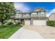 Charming two-story home featuring a landscaped front yard and a three-car garage and a yellow front door at 7320 Corwin Ct, Indianapolis, IN 46259